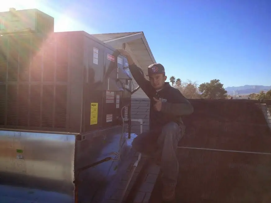 HVAC technician performing HVAC Inspection on a rooftop unit in Fairfield Plantation
